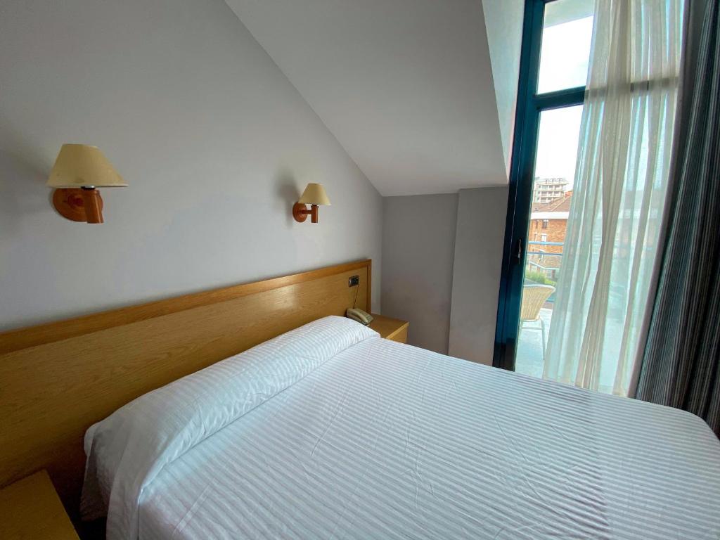 A bed or beds in a room at Hotel Soraya