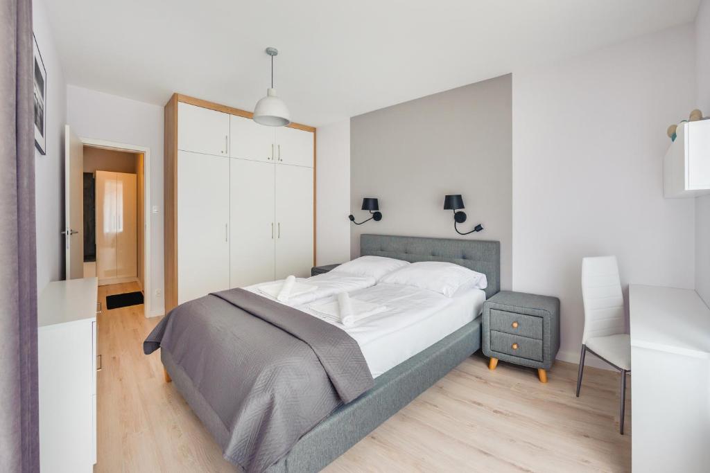 Posteľ alebo postele v izbe v ubytovaní Apartamenty Sun & Snow Enklawa