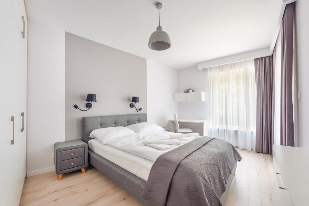Posteľ alebo postele v izbe v ubytovaní Apartamenty Sun & Snow Enklawa