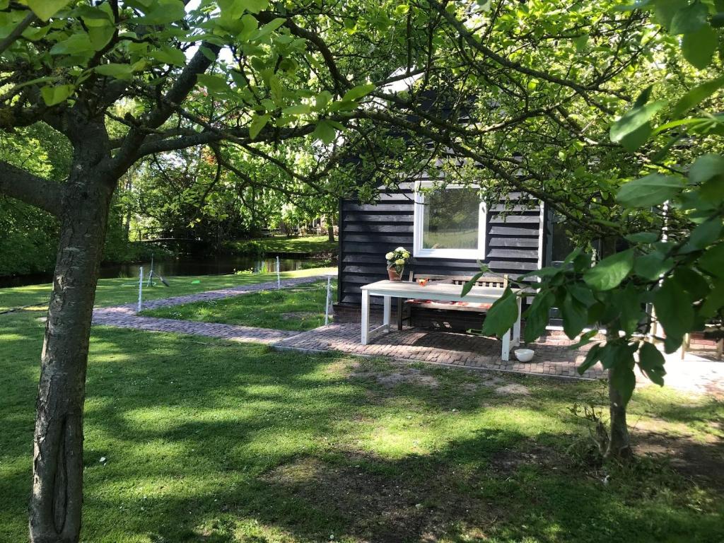 a picnic table in front of a tiny house at IJSSELMEER Lake houses in Andijk