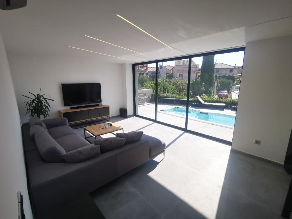 a living room with a large couch and a tv at SPA Apartment Vito in Vodice