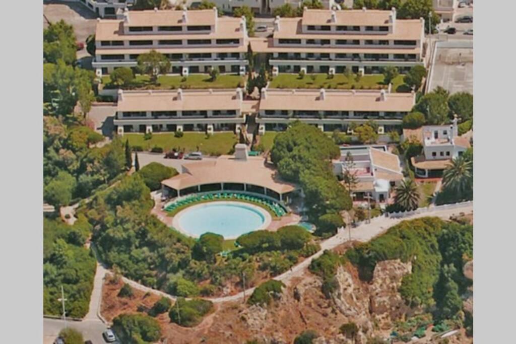 an aerial view of a building with a pool at Apartamento T1 - Praia Senhora da Rocha in Porches