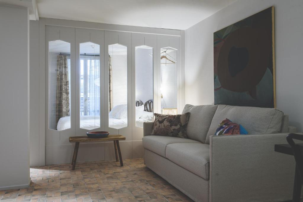 a living room with a couch and some windows at Pamplonapartments Pozo Blanco in Pamplona