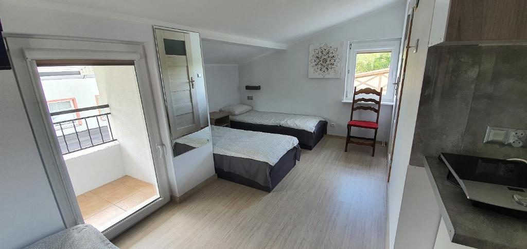 a small room with two beds and a bathroom at Dom Wypoczynkowy Oliwka in Ustka