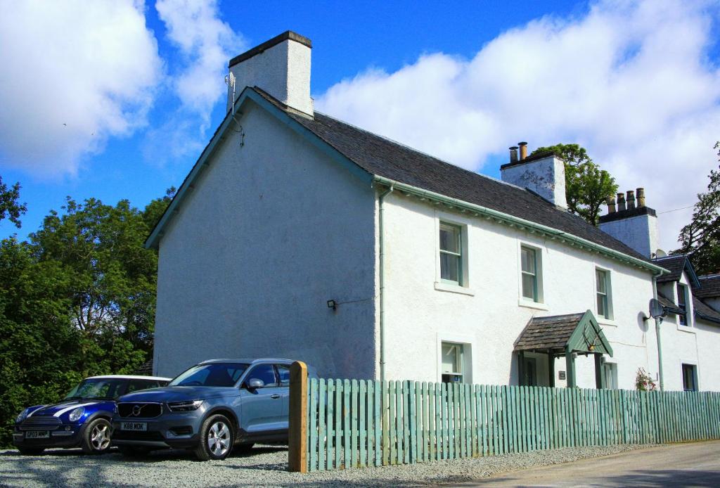 a car parked in front of a white house at Cladich House Bed & Breakfast in Cladich