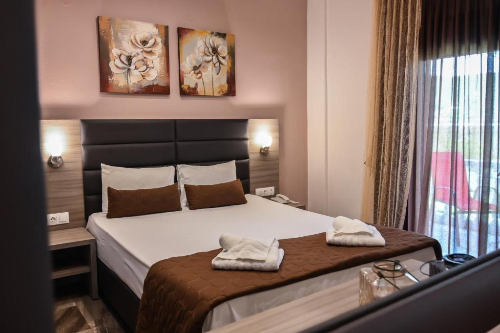 Posteľ alebo postele v izbe v ubytovaní Hotel Kostas