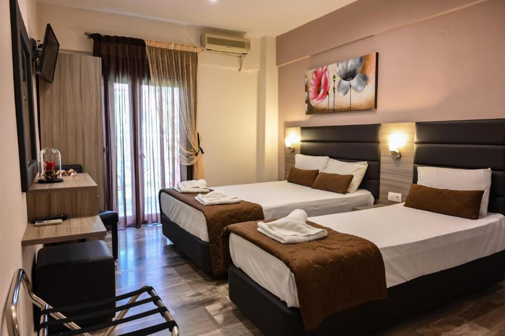 Posteľ alebo postele v izbe v ubytovaní Hotel Kostas