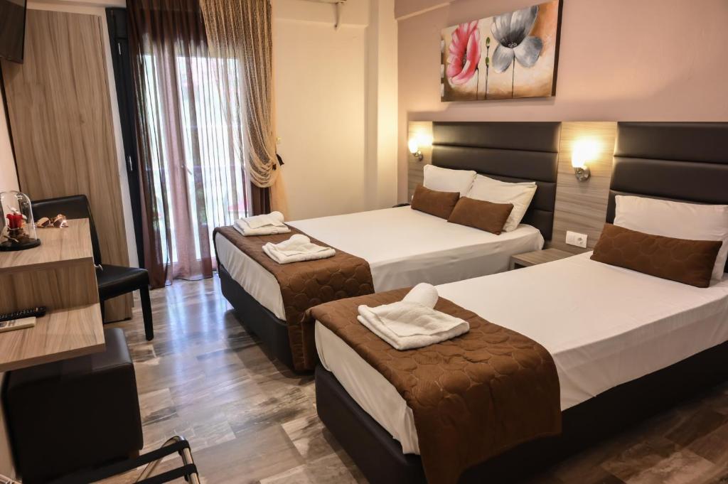 Posteľ alebo postele v izbe v ubytovaní Hotel Kostas