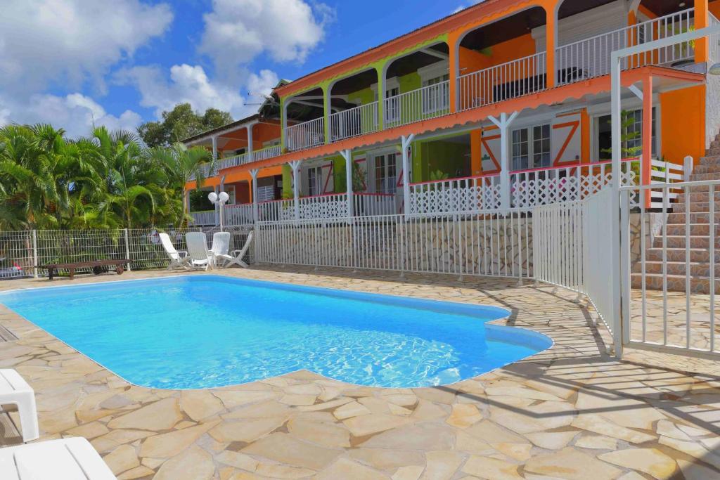 a swimming pool in front of a house at LE VILLAGE DE CANADA in Faup