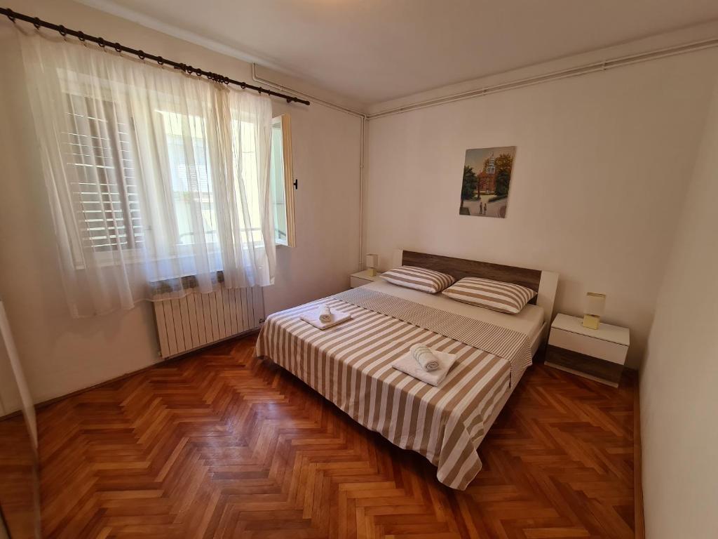 Postel nebo postele na pokoji v ubytování Apartments Ivana