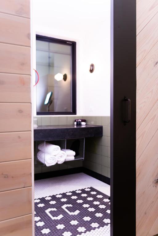 a bathroom with a sink and a mirror at Cotton Court Hotel, by Valencia Hotel Collection in Lubbock