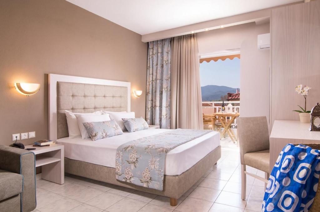 Habitación de hotel con cama y balcón en Hotel Olga en Sarti