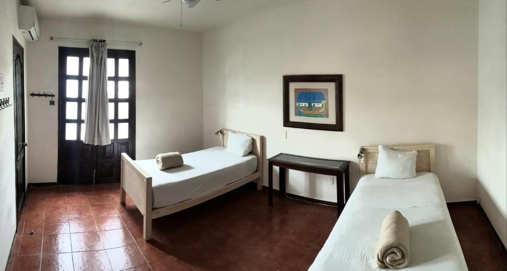 Кровать или кровати в номере Hostal de Las Américas