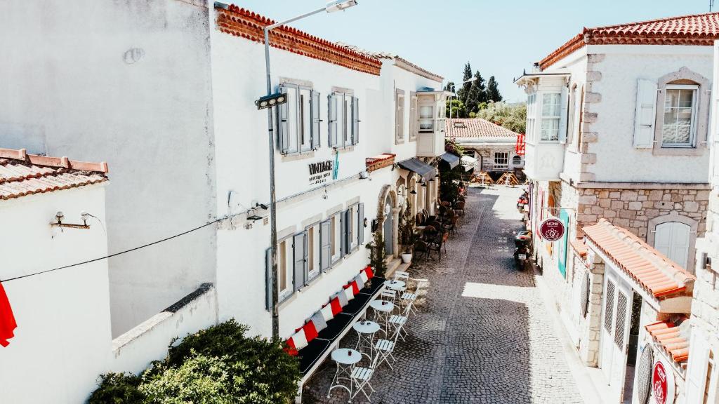 an alley in a town with white buildings at Vintage Hotel Alacati in Alaçatı