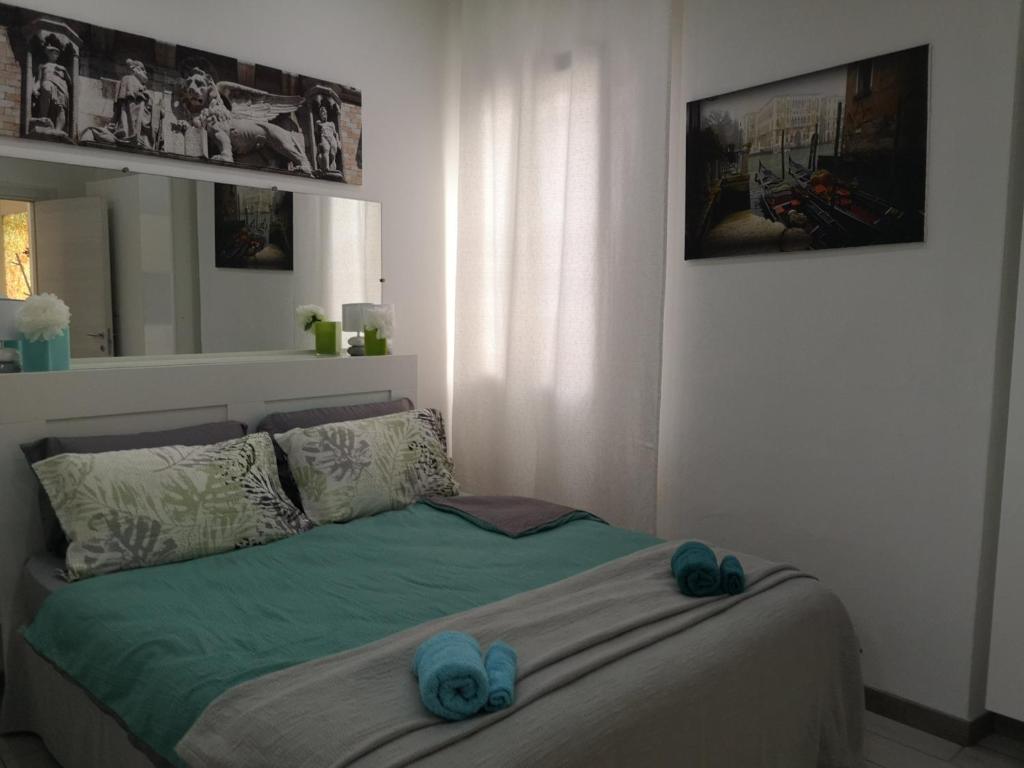 une chambre avec un lit avec des serviettes bleues dessus dans l'établissement 2BCENTRAL, à Desenzano del Garda