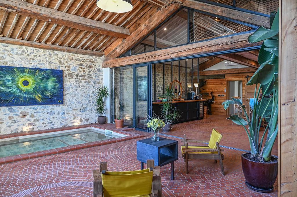a room with a pool in the middle of a building at La Remise Penthouse in Le Somail