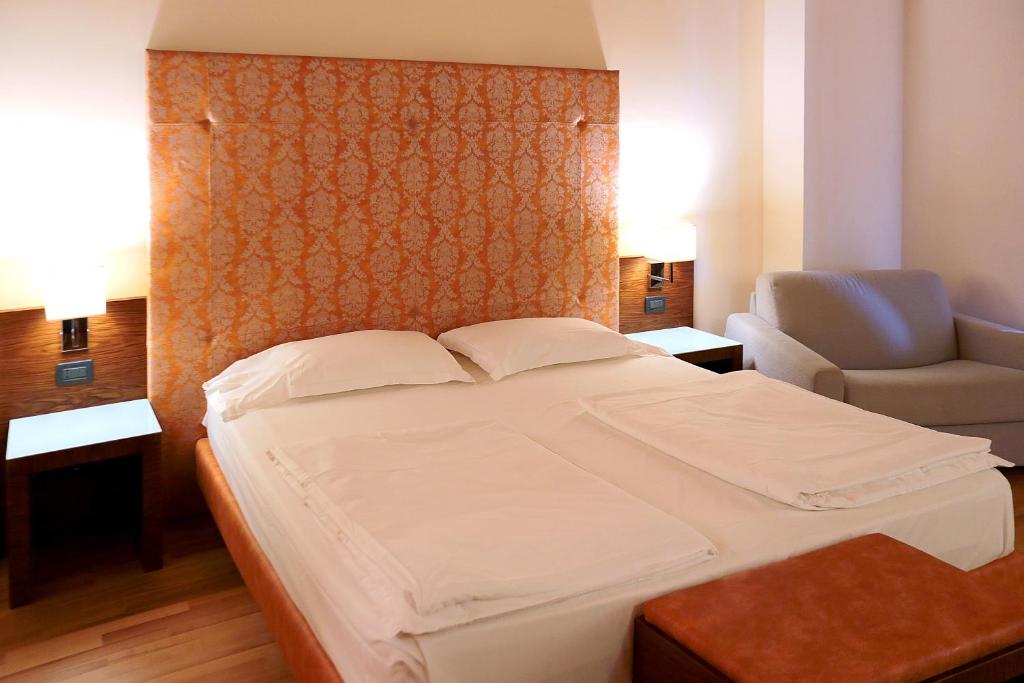 Łóżko lub łóżka w pokoju w obiekcie Hotel Lido