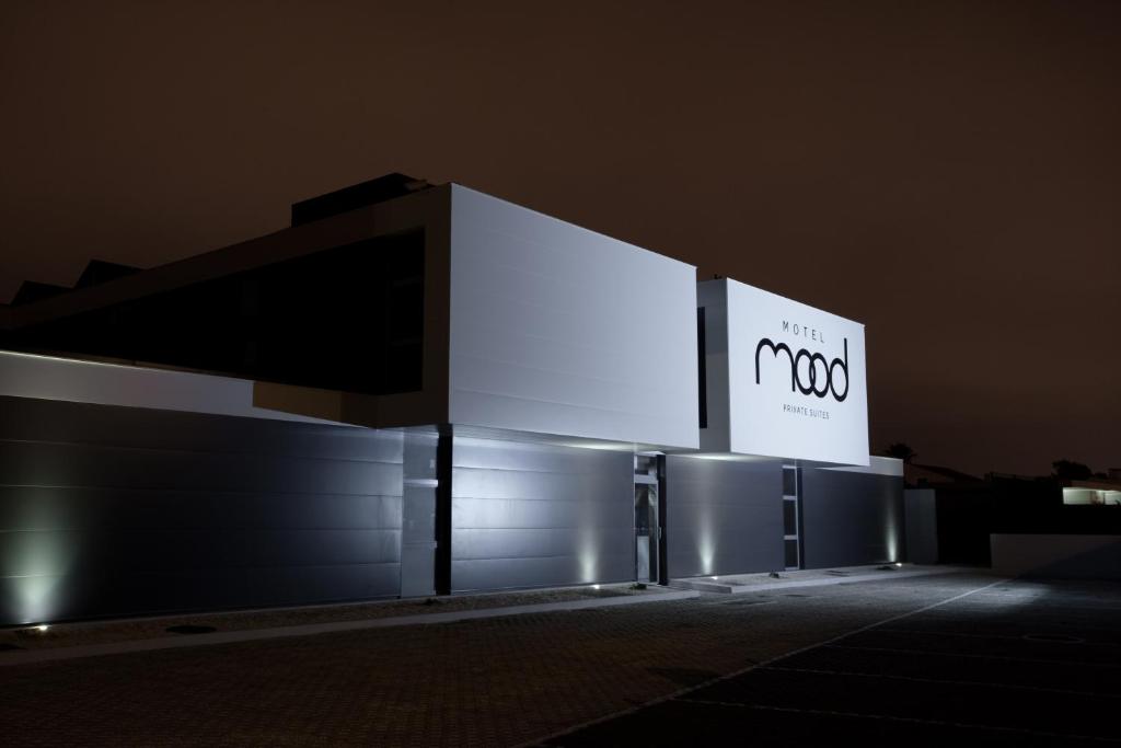 a building with a sign on it at night at Mood - Private Suites in Montijo