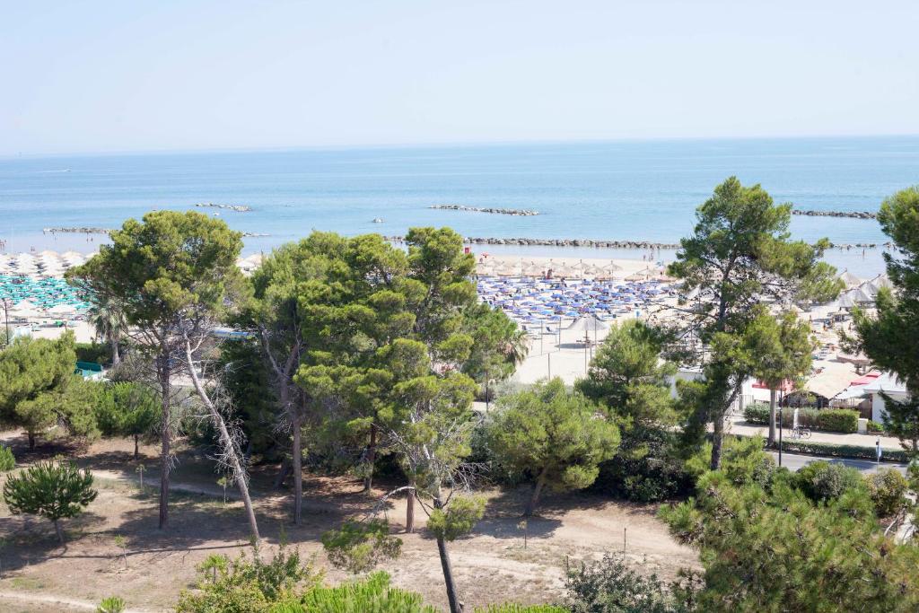 a view of a beach with trees and the ocean at L'Ancora B&B in Montesilvano
