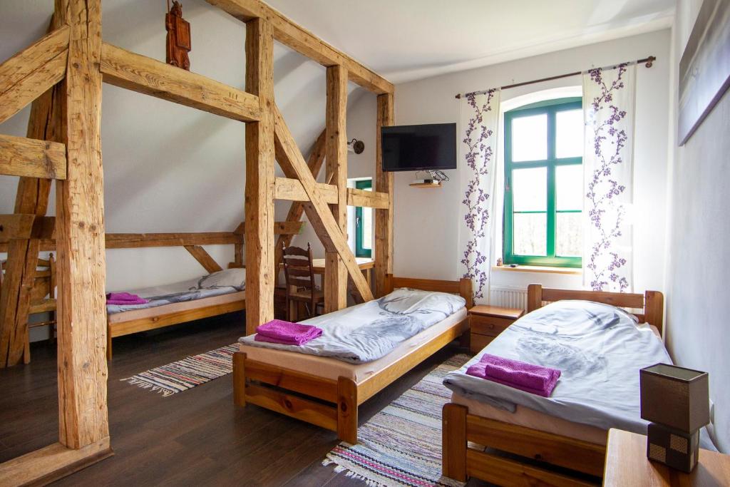 a room with two bunk beds and a tv at Gajówka in Węgorzewo