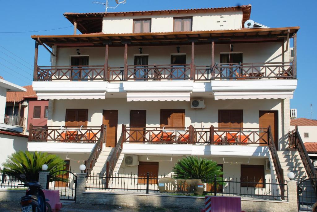 a large white building with balconies on it at VILA NIKOLETA in Ierissos