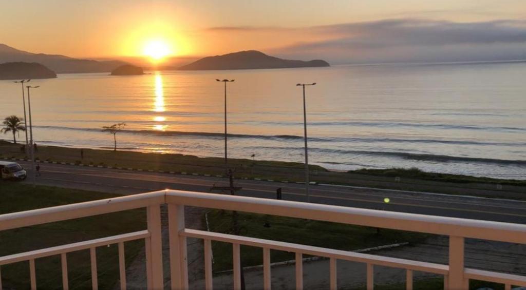 a sunset from the balcony of a condo at Praia de Massaguaçu in Caraguatatuba