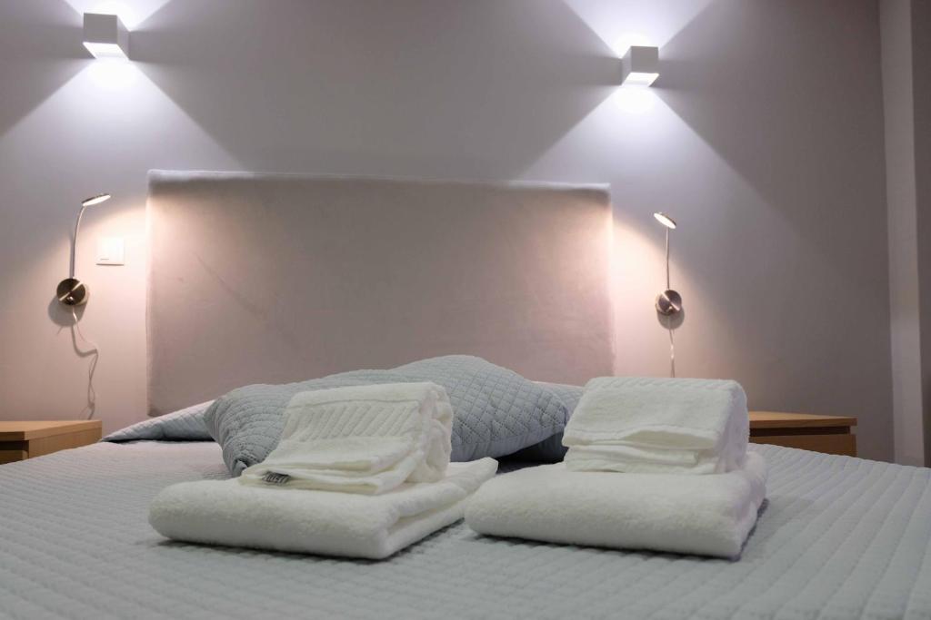 a bedroom with two white towels on a bed at MAGNIFIKSTYLE - Alojamento Local 1 in Guarda