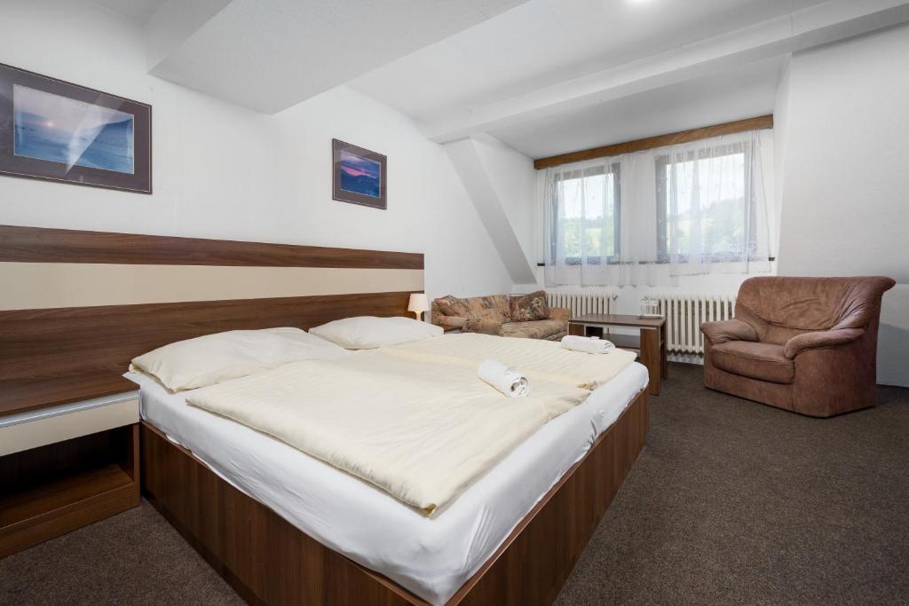 Postel nebo postele na pokoji v ubytování Horský Hotel Jelínek