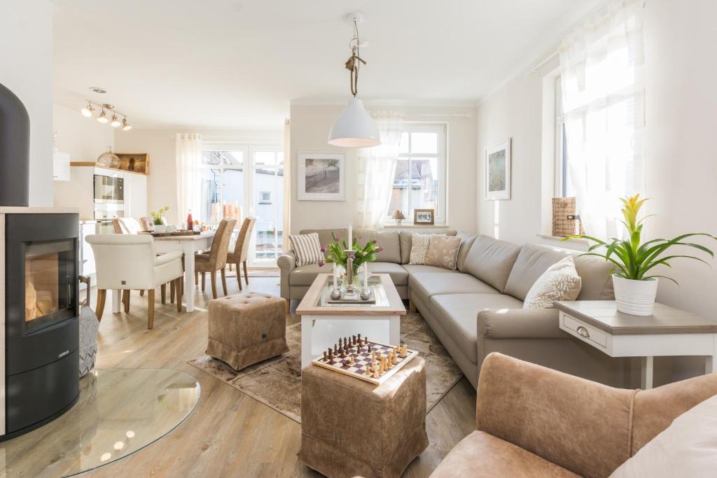 a living room with a couch and a table at Sanddollar in Zingst