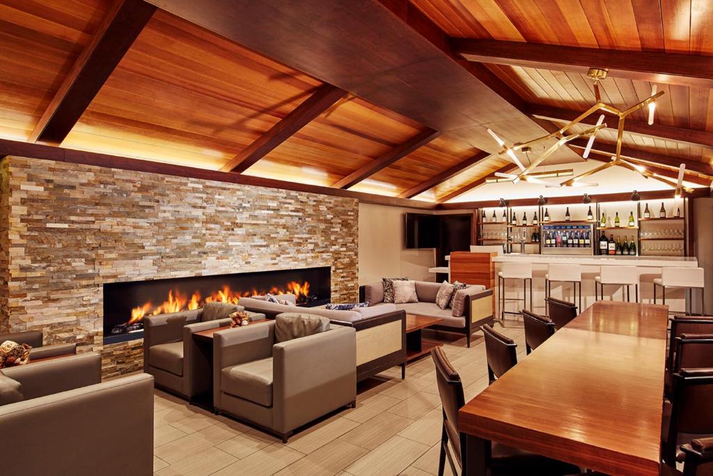 a living room filled with furniture and a fire place at The Nest Hotel Palo Alto in Palo Alto