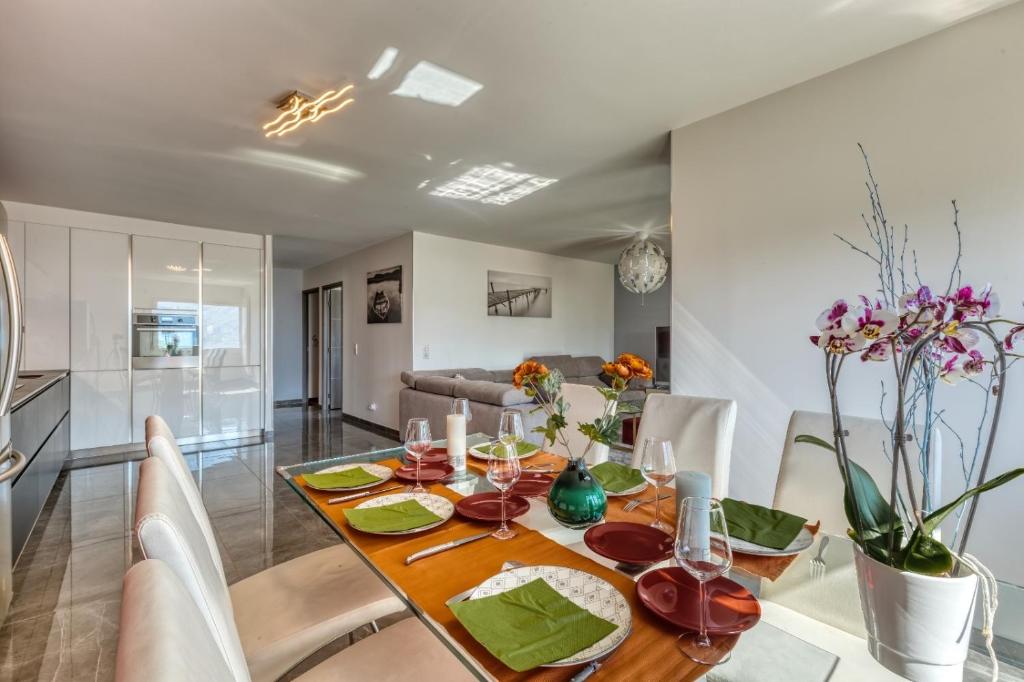 une cuisine et une salle à manger avec une table et des chaises dans l'établissement le panorama du lac, à Annecy