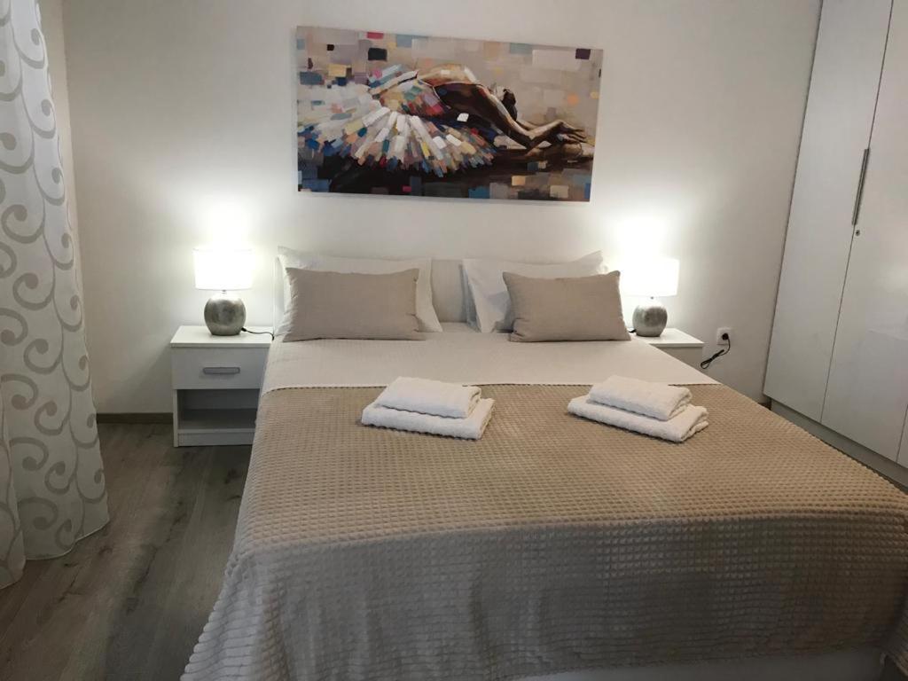 a bedroom with a bed with two towels on it at Rooms Marija in Split