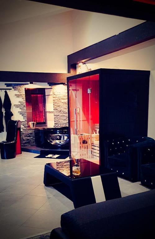 a living room with a red cabinet and a fireplace at Loft 47 Spa in Chambly
