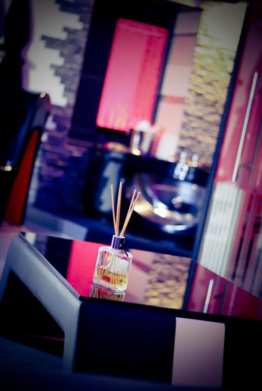 a table with a drink and chopsticks on top of it at Loft 47 Spa in Chambly