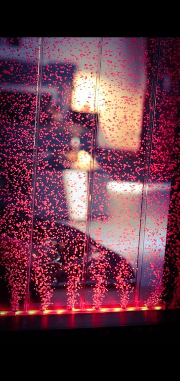 a view of a city from a window with red lights at Loft 47 Spa in Chambly