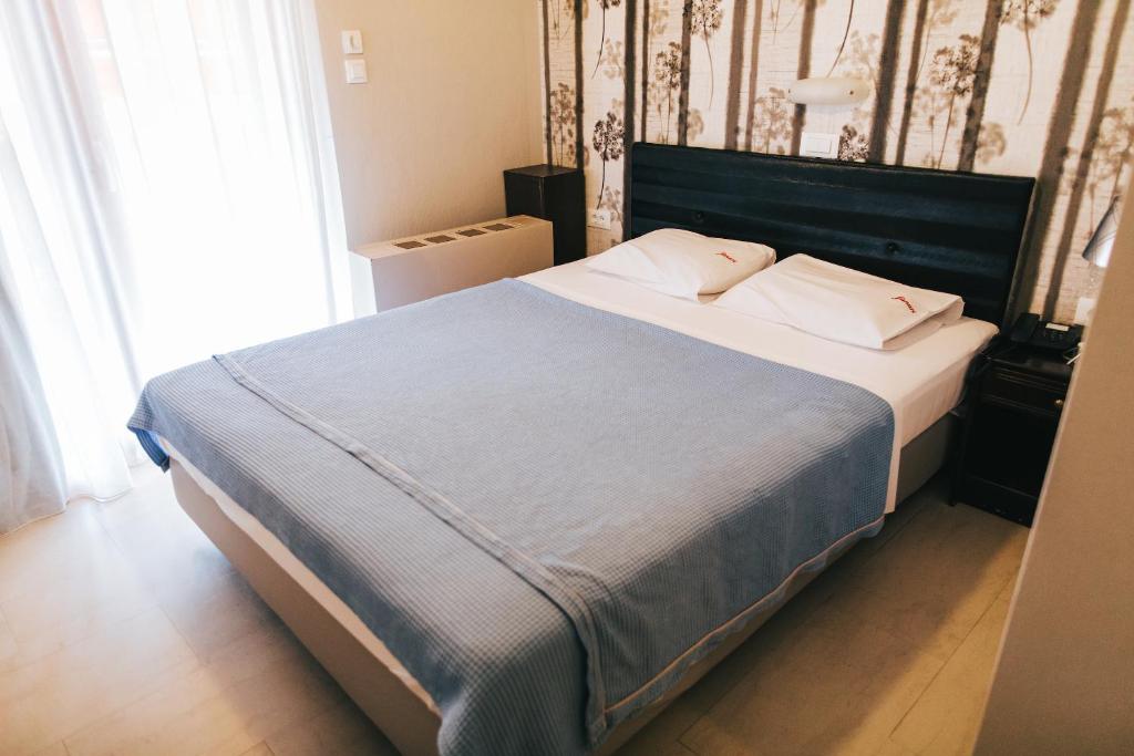 Postel nebo postele na pokoji v ubytování Fanari Hotel