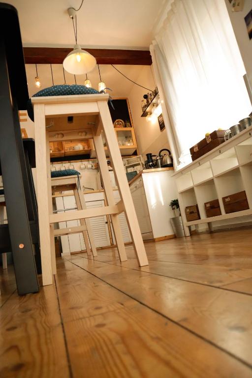 a kitchen with a stool in the middle of a room at Guest House Camilla in Alghero