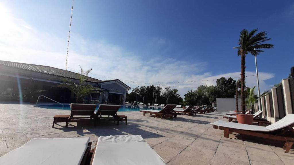 a pool with chaise lounge chairs and a resort at Zanzibar in Filiaşi