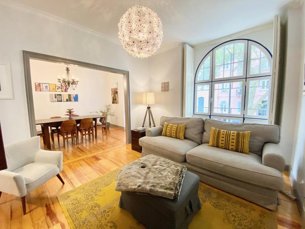 a living room with a couch and a table at Luxury Vintage apartment by MyPlaceForYou, at the city centre next to Marquês de Pombal in Lisbon