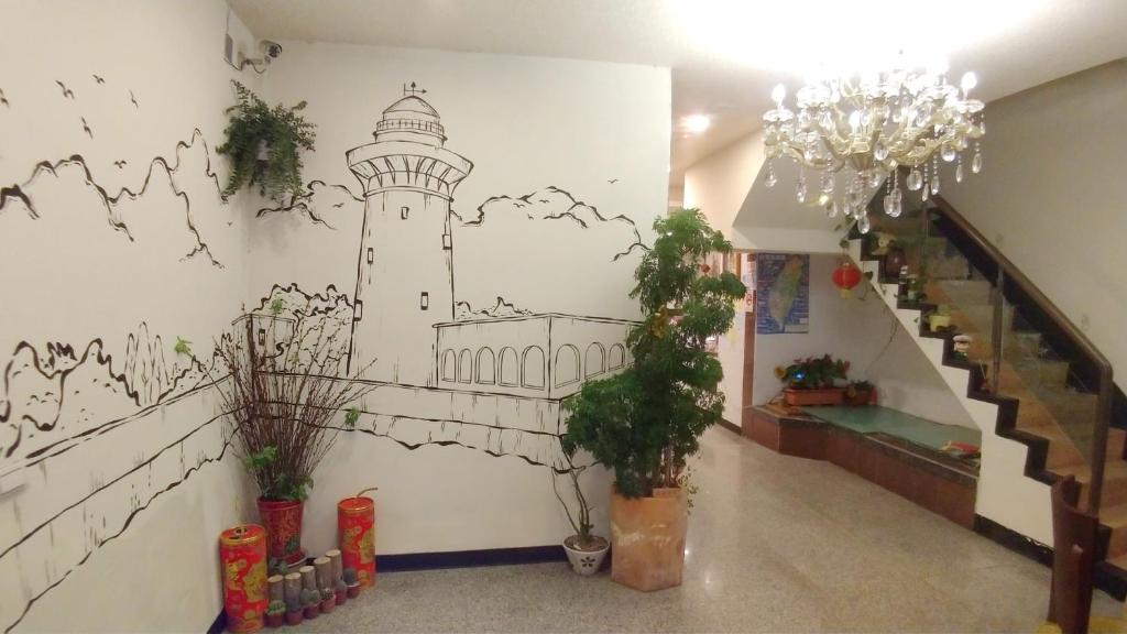 a wall with a drawing of a lighthouse on it at Kenting Heng-Chung Art Hostel in Hengchun South Gate