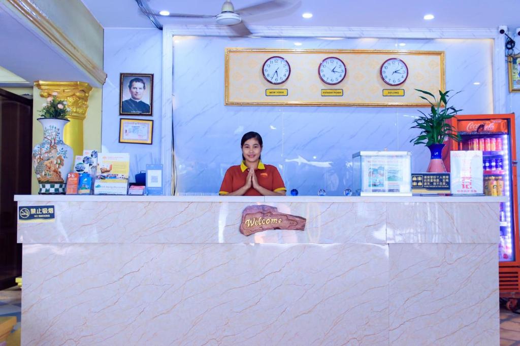 a woman standing behind a counter in a store at Don Bosco Guesthouse in Sihanoukville
