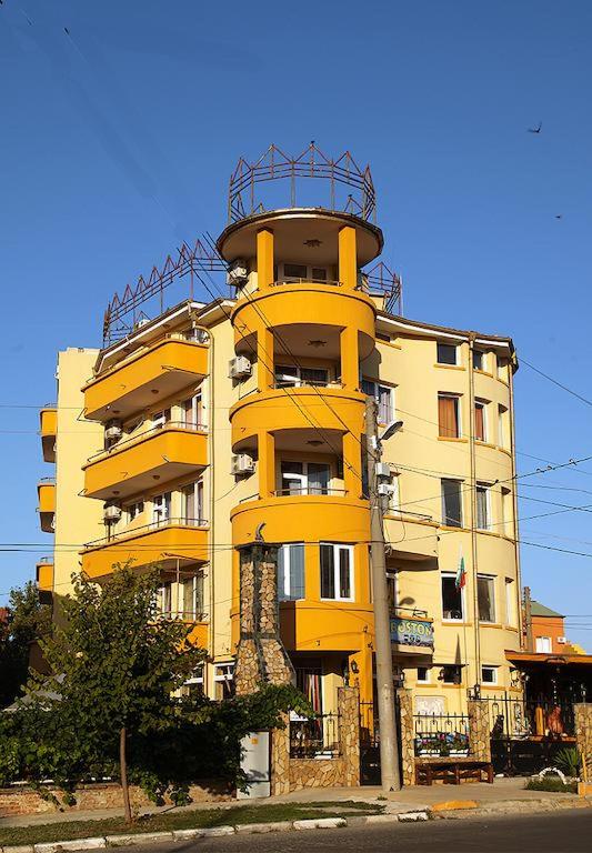 a yellow apartment building with a balcony at Семеен хотел Бостън in Ravda