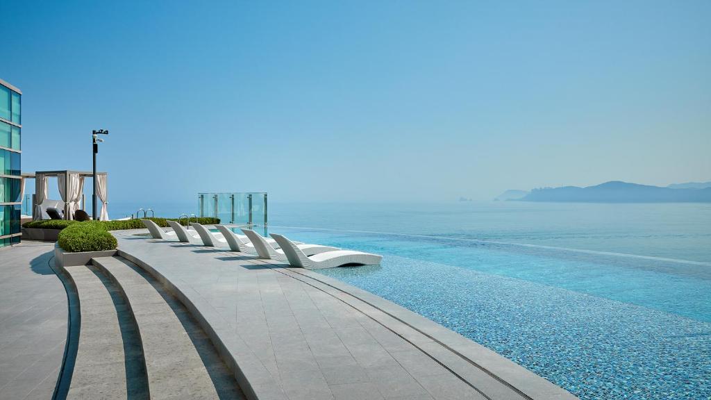a swimming pool with a view of the ocean at Signiel Busan in Busan