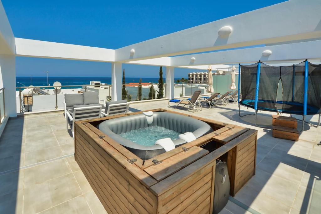 a hot tub on the deck of a house at Seafront Protaras Apartments in Protaras