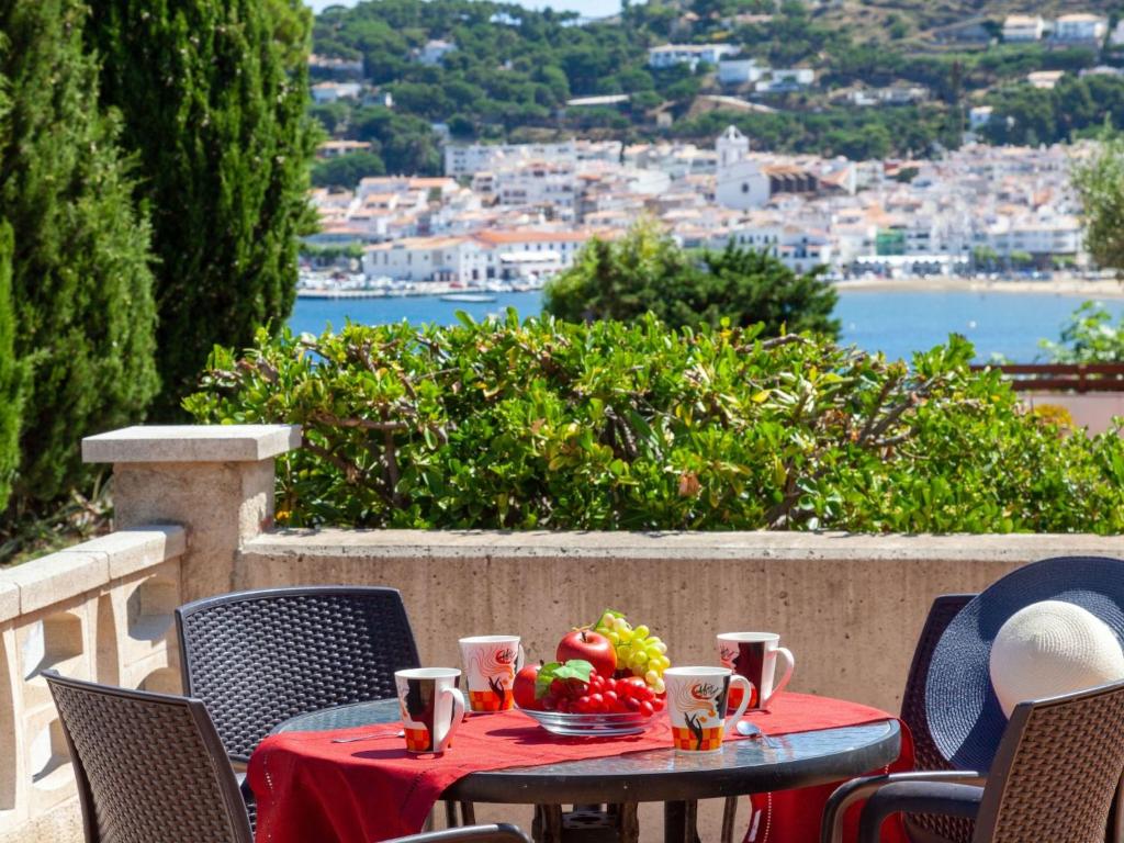 a table with a bowl of fruit on top of a balcony at Apartment Villa Cordoba-1 by Interhome in Port de la Selva