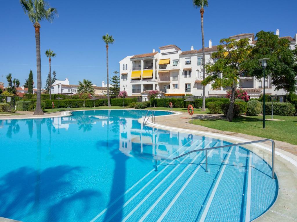 a large swimming pool in front of a building at Apartment Lorcrisur by Interhome in Marbella