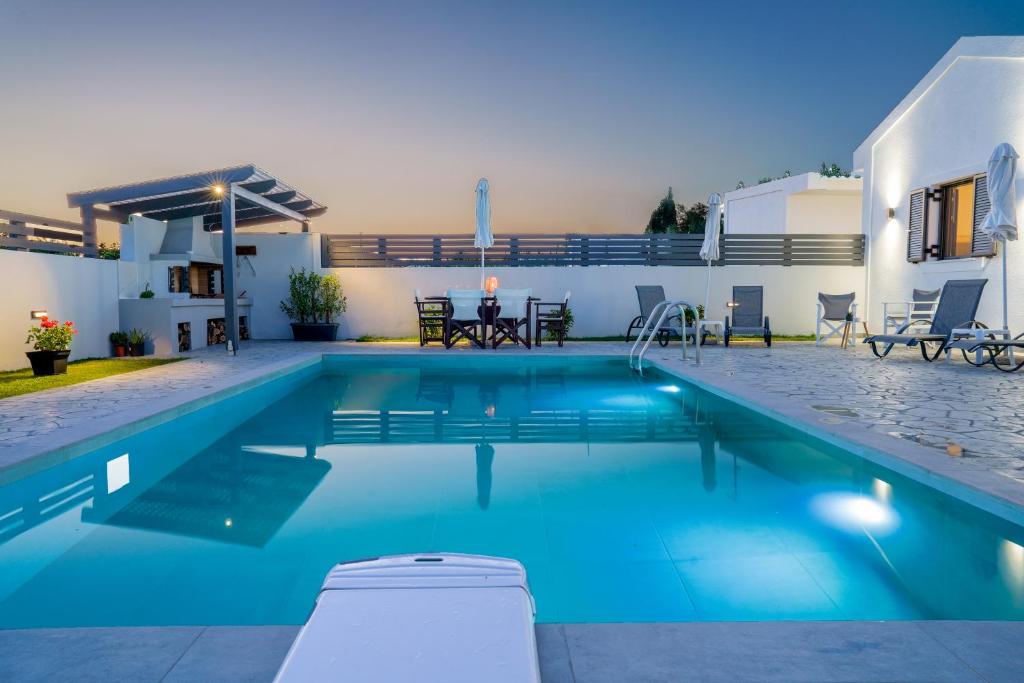 a swimming pool in the backyard of a villa at BlueWind Villa in Zakynthos