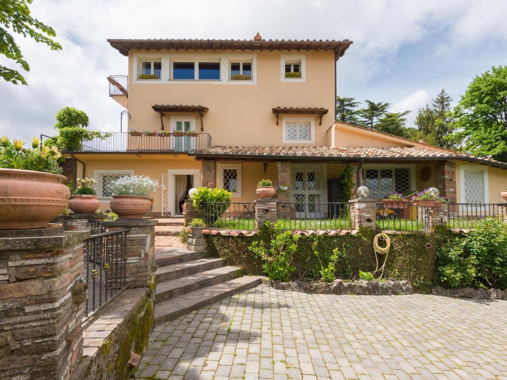 a large house with a fence in front of it at Villa Vista da Rocca di Papa-2 by Interhome in Rocca di Papa