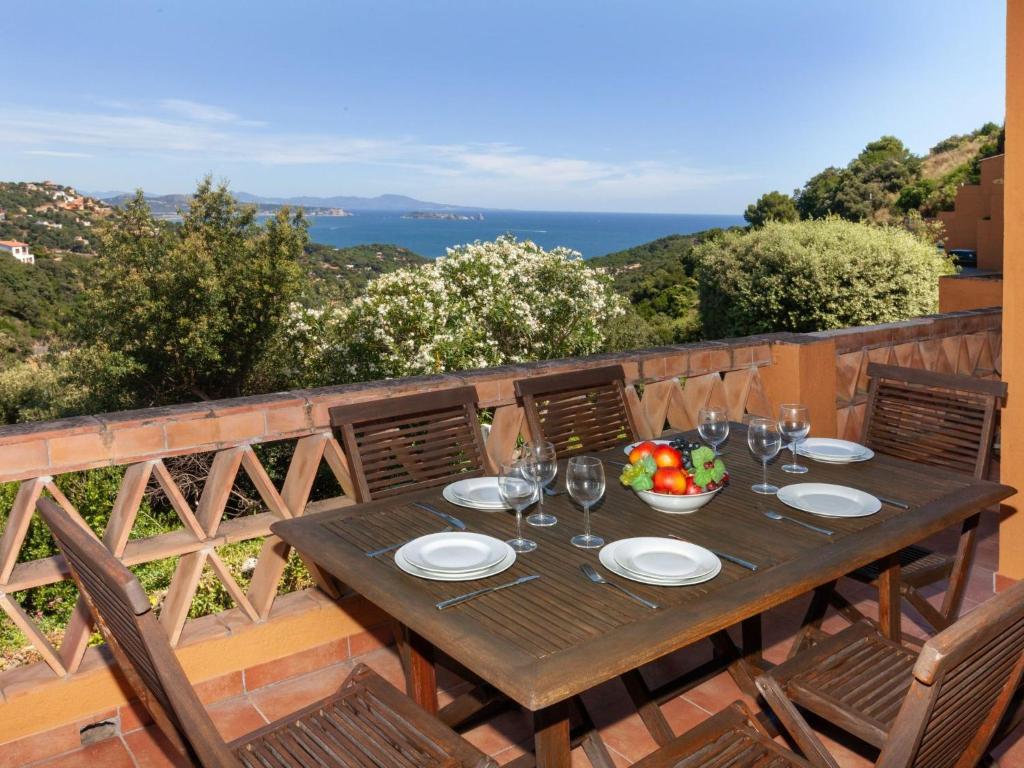 a wooden table with wine glasses and a bowl of fruit at Holiday Home Xarmada Cecilia by Interhome in Begur