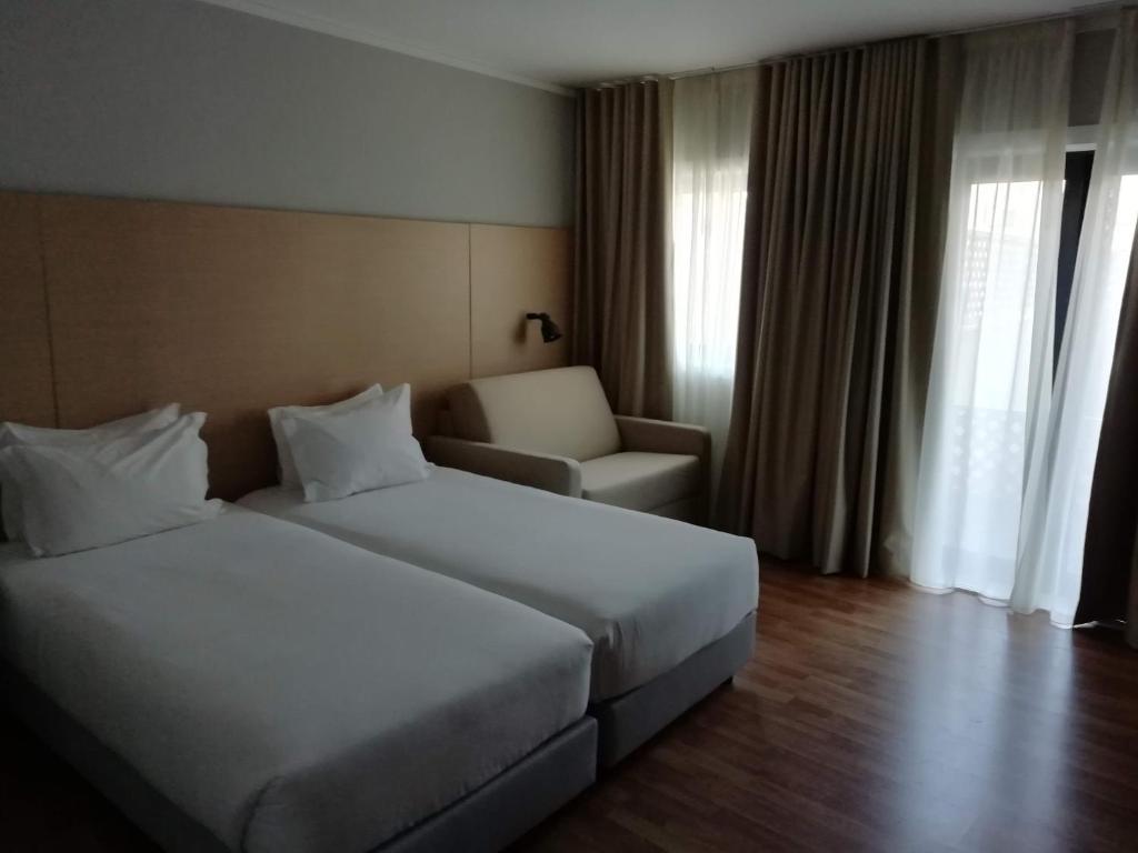 Cama ou camas em um quarto em ClipHotel